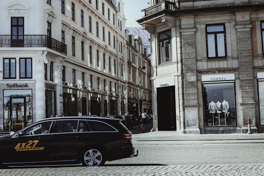 A busy urban shopping street filled with fast fashion stores